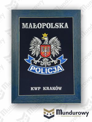 Zdjęcie przedstawiające Tablo pamiątkowe z odznaką POLICJI - KWP Małopolska