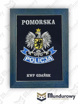 Zdjęcie przedstawiające Tablo pamiątkowe z odznaką POLICJI - KWP Pomorska