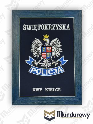 Zdjęcie przedstawiające Tablo pamiątkowe z odznaką POLICJI - KWP Świętokrzyska